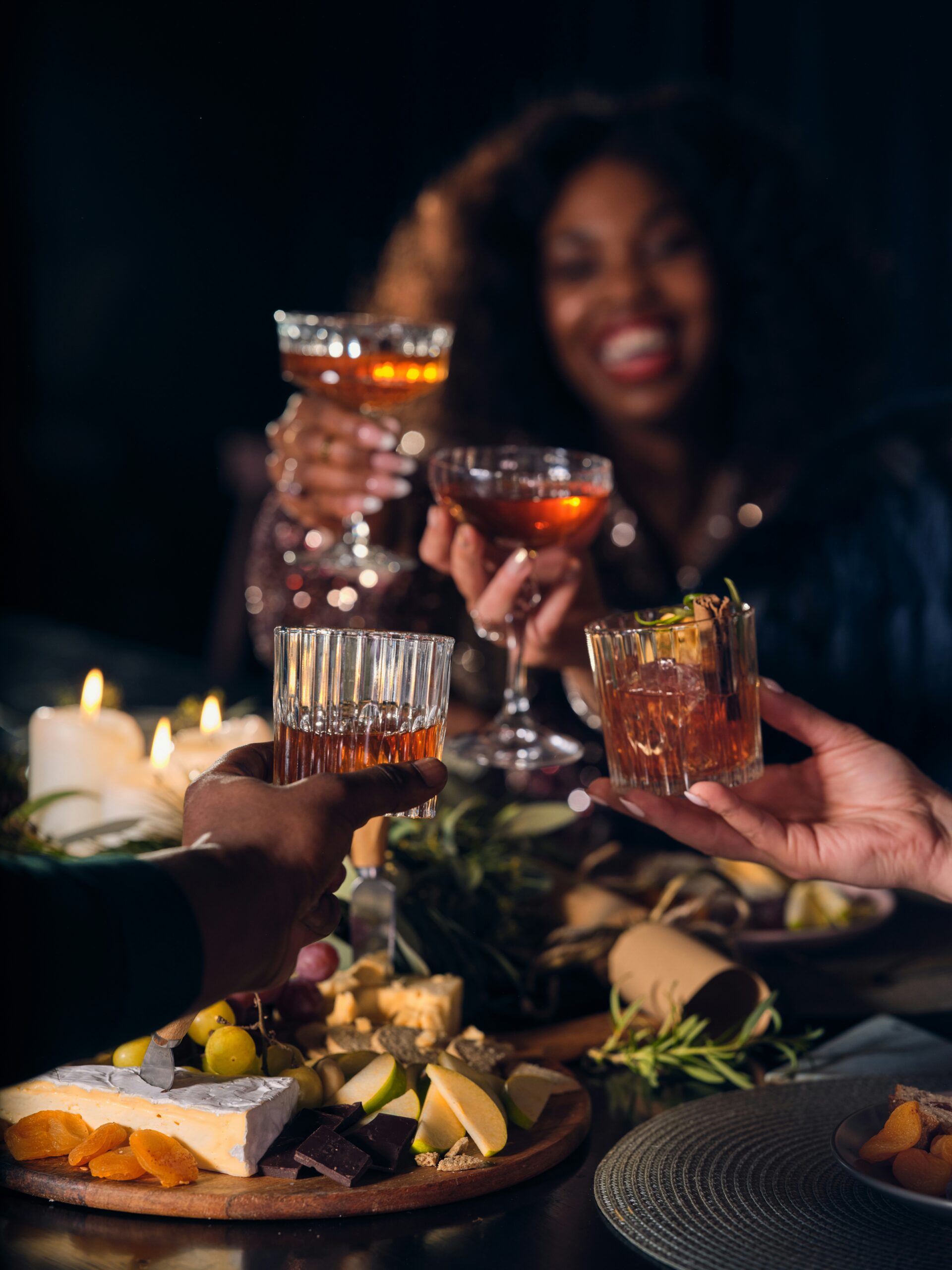 “a group of people toasting with drinks” by OurWhisky Foundation. Friends drinking whisky and cocktails at a Christmas dinner party. This image is part of the OurWhisky Foundation’s Modern Face of Whisky library, designed to challenge gender bias and improve the diversity of whisky drinkers portrayed in the media. Credit: Christina Kernohan and the OurWhisky Foundation. Published on November 11, 2023. Camera: FUJIFILM, GFX100S. Free to use under the Unsplash License.