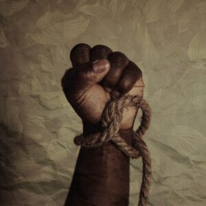 “brown leather strap on white textile” by Tasha Jolley. Black power of the celebration of Juneteenth, now a national Holiday. Texas, USA. Published on June 19, 2021. Camera: Canon, EOS R. Free to use under the Unsplash License.