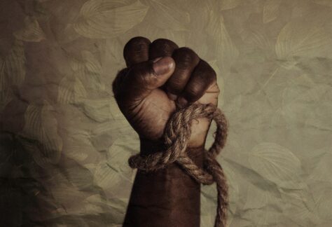 “brown leather strap on white textile” by Tasha Jolley. Black power of the celebration of Juneteenth, now a national Holiday. Texas, USA. Published on June 19, 2021. Camera: Canon, EOS R. Free to use under the Unsplash License.